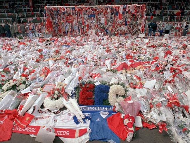 FILE - In this April 17, 1989 file photo, floral tributes are placed by soccer fans at the 'Kop' end of Anfield Stadium in Liverpool, England, 2 days after the Hillsborough April 15 tragedy when fans surged forward during the cup semifinal between Liverpool and Nottingham Forest at Hillsborough Stadium killing 96 people. British prosecutors on Wednesday June 28, 2017, are set to announce whether they plan to lay charges in the deaths of 96 people in the Hillsborough stadium crush _ one of Britainâ€™s worst-ever sporting disasters. (AP Photo/ Peter Kemp, file)