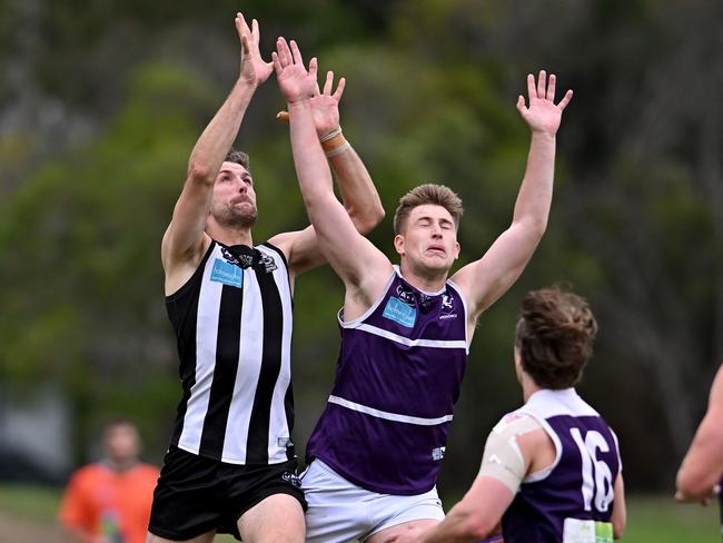 Ivanhoe’s James Course and Brunswick’s Ben Wilson fly for a mark. Picture: Andy Brownbill