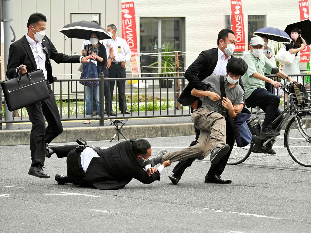 A man suspected of shooting former Japanese prime minister Shinzo Abe was tackled to the ground by police at Yamato Saidaiji Station in the city of Nara on July 8, 2022. Picture: Asahi Shimbun / AFP