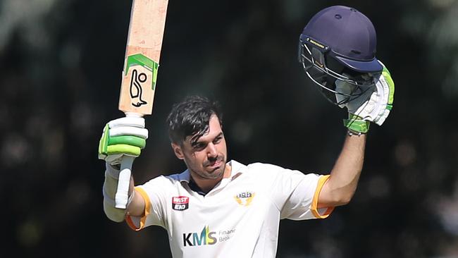 Bailey Capel raises his bat on reaching a century last season. The young opener now has six first grade hundreds to his name at West Torrens. Picture: Dean Martin