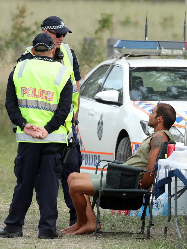 Police with a man at a drug testing site near the festival. Photographer: Liam Kidston