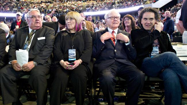 Warren Buffett, chairman of Berkshire Hathaway Inc., second from right, sits with his kids, from left, Howard, Susie and Peter on the floor of the Berkshire Hathaway shareholders meeting at the Qwest Center in Omaha, Nebraska, in 2011. Picture: Daniel Acker/Bloomberg