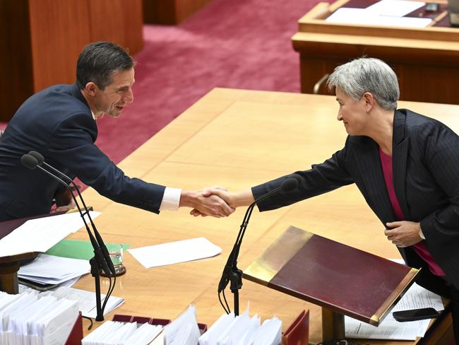 CANBERRA, AUSTRALIA  - NewsWire Photos - November 28, 2024: Senator Penny Wong congratulates Senator Simon Birmingham after his valedictory speech in the Senate at Parliament House in Canberra. Picture: NewsWire / Martin Ollman