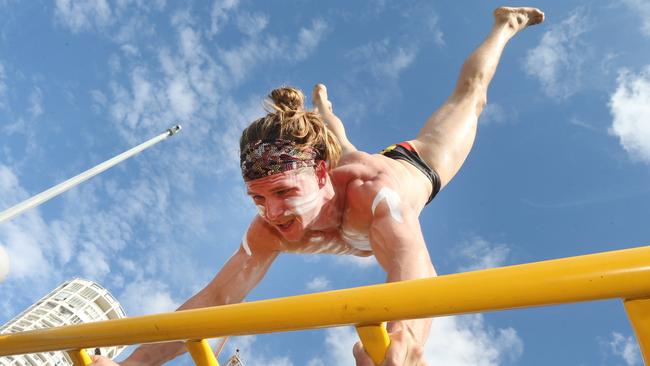 Australian Ninja Warrior Gold Coast contestant Jack Wilson flies high in Surfers Paradise. Picture: Mike Batterham