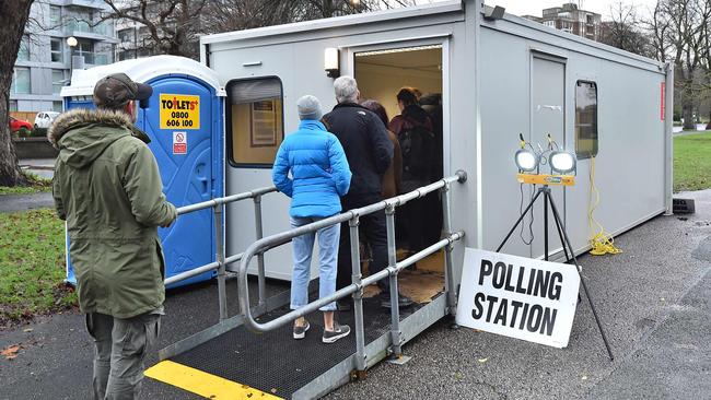 Voters queue at the entrance of a portacabin set up as a polling station in Brighton and Hove. Picture: Glyn Kirk/AFP