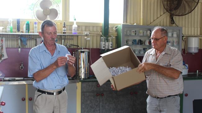 Kingaroy Men's Shed president Chris Price drawing the winning raffle tickets from vice president Eric Ford. Photo: Laura Blackmore