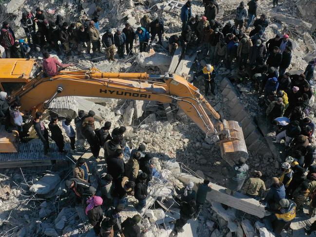 This aerial view shows rescuers searching for survivors amid the rubble of a collapsed building in the town of Harim in Syria's rebel-held northwestern Idlib province. Picture: AFP