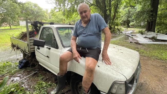 Samford resident Dennis Hanelt sat on the bonnet of this ute for several hours to escape floodwaters. Picture: Iwan Jones