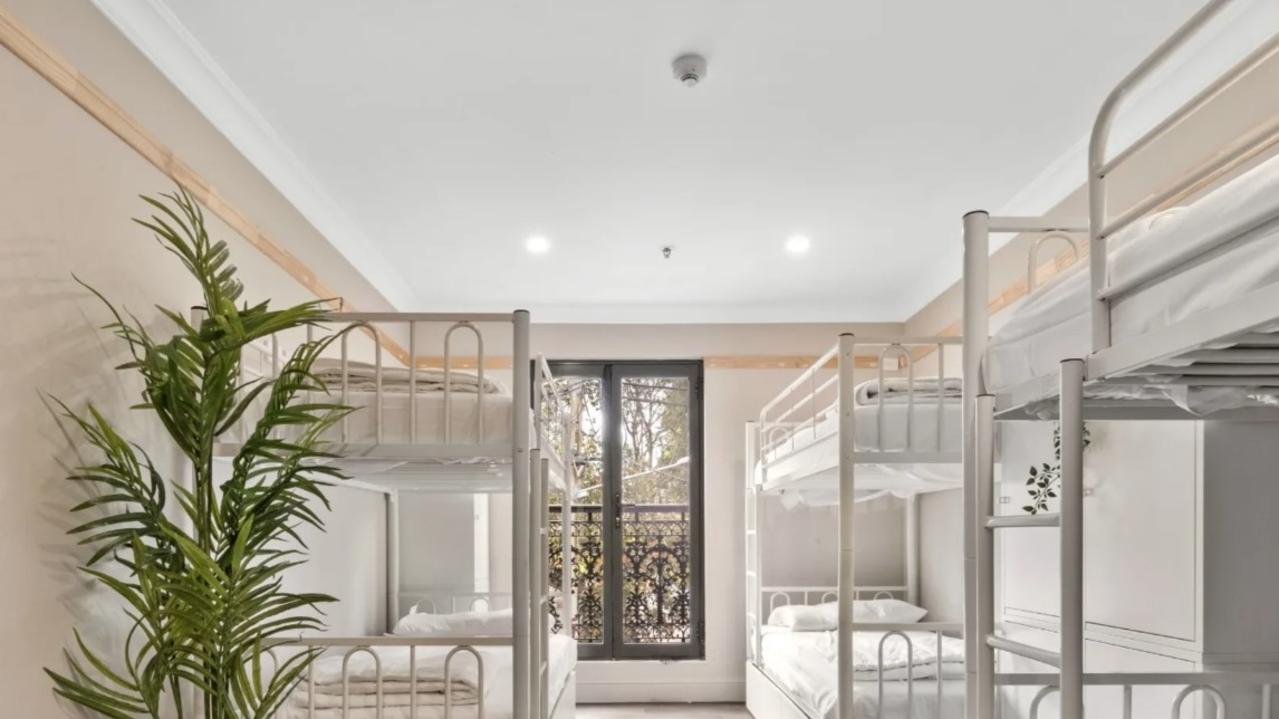 A room in a Darlinghurst home with six beds in it.