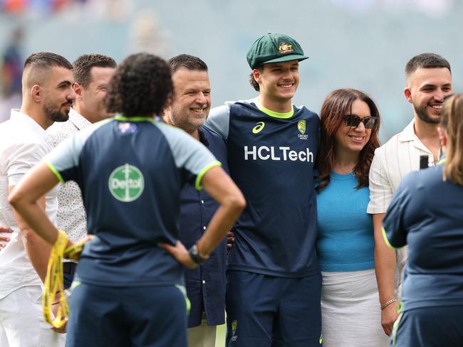 Konstas poses for photographs with his family after being presented with his baggy green on Boxing Day. Picture: Getty