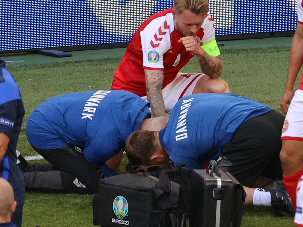 Paramedics treat Christian Eriksen after Denmark captain Simon Kjaer performed CPR.