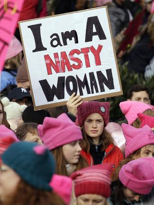 A woman holds a sign amidst a sea of pink caps in Seattle. Picture: AP Photo/Elaine Thompson