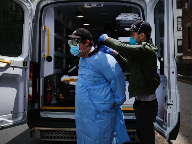 New York medics suit up in personal protective equipment (PPE), as they prepare to pick up a COVID-19 patient. Picture: Getty Images/AFP