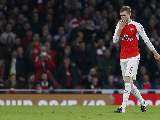 Arsenal's Per Mertesacker walks off the pitch after being sent off.