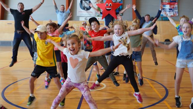 Gus Worland (left) the founder of Gotcha4Life, practising for the Star Jump Challenge with children and Chief Inspector Warren Hamilton, Operational Coordinator, Youth &amp; Crime Prevention Command (rear left) and PCYC NSW CEO, Dominic Teakle (rear right) at the Northern Beaches Police Citizens Youth Club at Dee Why on Monday. Picture: NSW PCYC