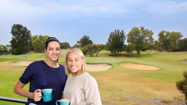 Erin Phillips and wife Tracy Gahan on the balcony of the West Lakes home they are selling. Image/Russell Millard Photography