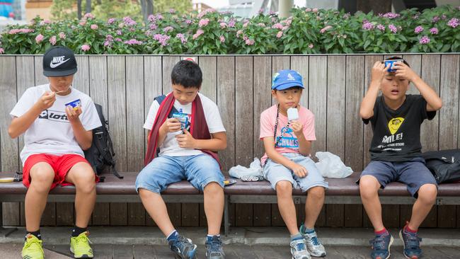 Children in Tokyo cool off with an ice cream during last year’s heatwave in Tokyo. Picture: Getty Images