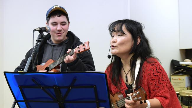 Izumi Nago with music therapy student, Phillip Pogossov at her studio in Pennant Hills Tuesday July 24, 2018. She runs music classes for kids with disabilities. (AAP IMAGE/Simon Bullard)