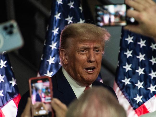 Former US President and 2024 presidential hopeful Donald Trump arrives to speak at Drake Enterprises, an automotive parts manufacturer and supplier, in Clinton, Michigan, on September 27, 2023. Both Trump and Biden are visiting Michigan this week, in what is their first major skirmish of a long fight for voters in working-class swing states ahead of the November 2024 election. Biden on September 26, 2023, became the first sitting president to stand on a picket line, supporting calls by the United Auto Workers (UAW) union for the Big Three Detroit carmakers to raise wages. And Trump is skipping a debate in California with his trailing Republican rivals on September 27 to head instead for a small, non-union car parts factory on the other side of Detroit. (Photo by Matthew Hatcher / AFP)