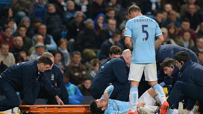 Medical staff prepare to stretcher off Manchester City's midfielder David Silva following