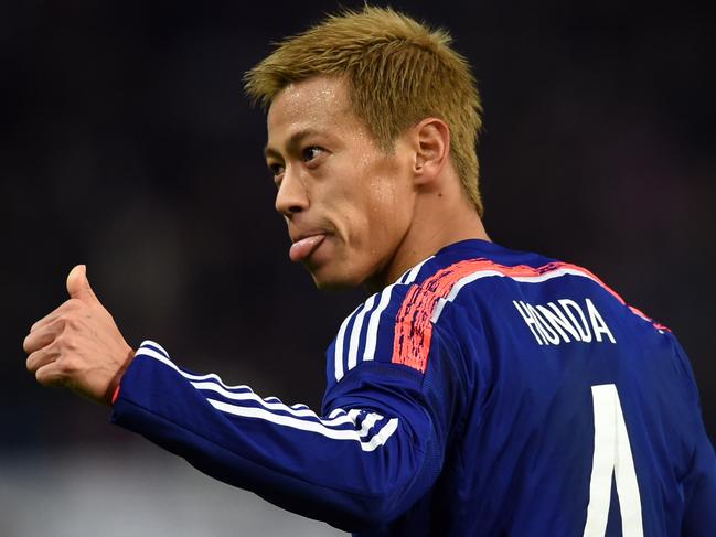 TO GO WITH Fbl-Asia2015-JPN by Alastair HIMMER (FILES) This file photo taken on November 14, 2014 shows Japan's forward Keisuke Honda celebrates his goal during their friendly match against Honduras in Toyota, Aichi prefecture. Japan playmaker Keisuke Honda has fired a volley at Asian Cup organisers over the tournament's punishing schedule, just days after being fined for slamming the standard of refereeing. AFP PHOTO / FILES / TOSHIFUMI KITAMURA