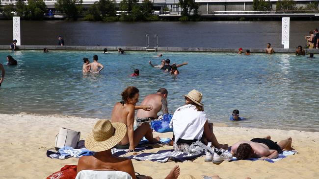 Queenslanders cool off at the South Bank beach and walking and cycling next to the Brisbane river. Picture: NCA NewsWire / Tertius Pickard