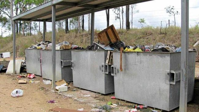 An older photo of bins overflowing at Woolooga.