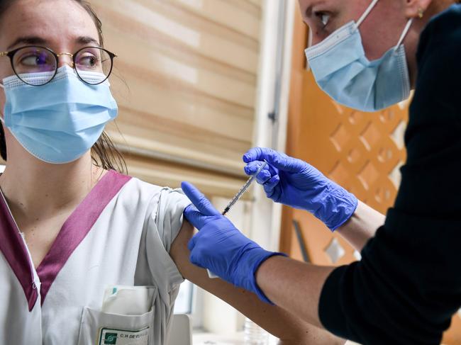 A health worker is vaccinated with the AstraZeneca/Oxford Covid-19  vaccine on February 7, 2021 at the Mignot Hospital in Le Chesnay near Paris. - The top French medical authority Haute autoritÃ© de SantÃ© has approved the vaccine for use in France, but only for people under 65, echoing decisions made in Sweden, Germany, Belgium and Switzerland over concerns about a lack of data on the effectiveness of the vaccine for over 65s. (Photo by ALAIN JOCARD / AFP)