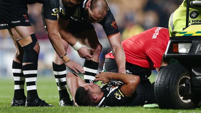 Gerard Beale of the Kiwis is checked by teammates Simon Mannering and Dallin Watene-Zelezniak after suffering an injury.