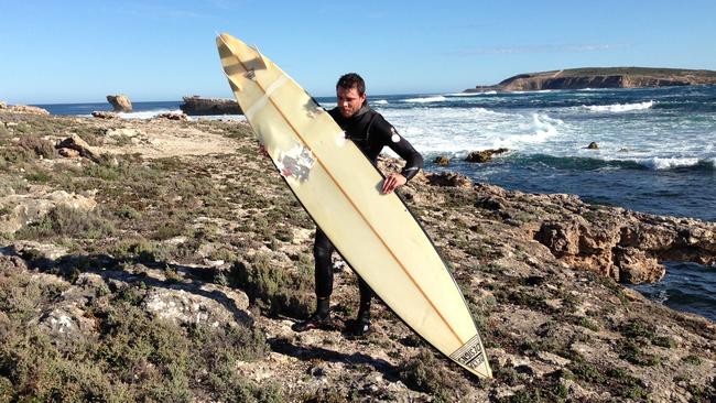 Elliston shark attack victim Andrew “Monkey” McLeod with his damaged board.