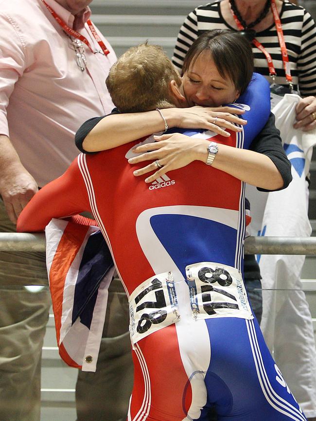 Sir Chris Hoy gets a hug of his wife Lady Sarra as mum Carol and dad David look on.