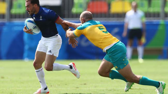 RIO DE JANEIRO, BRAZIL — AUGUST 09: Terry Bouhraoua of France is tackled by James Stannard of Australia during the Men's Rugby Sevens Pool B match between Australia and France on Day 4 of the Rio 2016 Olympic Games at Deodoro Stadium on August 9, 2016 in Rio de Janeiro, Brazil. (Photo by David Rogers/Getty Images)