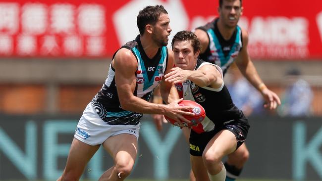 Jack Steele about to tackle Travis Boak. Picture: AFL Photos