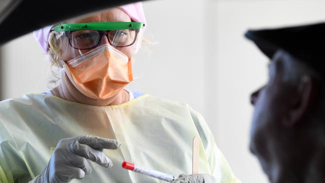 Nurse Shirley Molloy prepares to swab a patient for COVID-19 at a drive-through Fever Clinic in Caloundra on the Sunshine Coast. Picture: AAP/Dan Peled