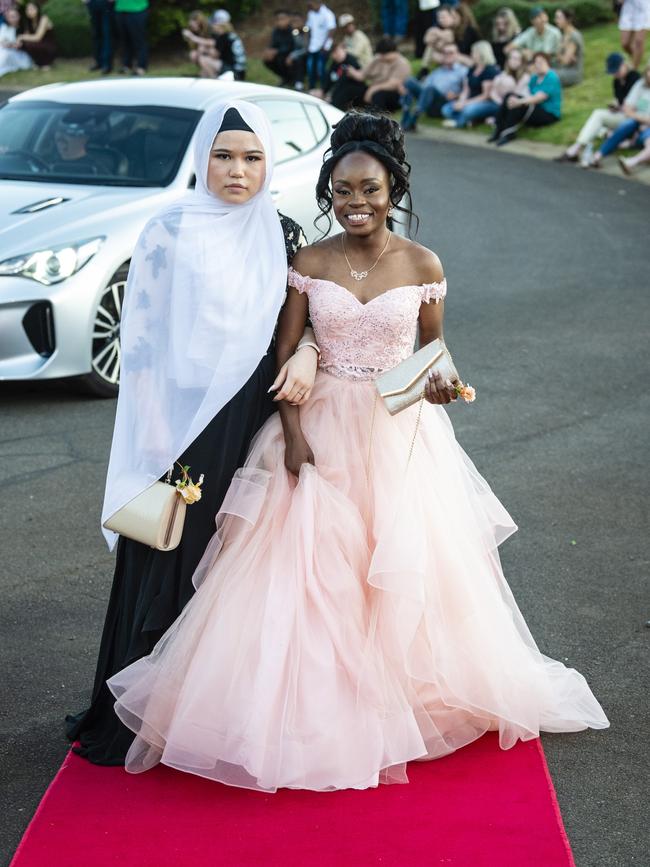 Sakina Damarda (left) and Neema Mwamba Wilongella arrive at Harristown State High School formal at Highfields Cultural Centre, Friday, November 18, 2022. Picture: Kevin Farmer