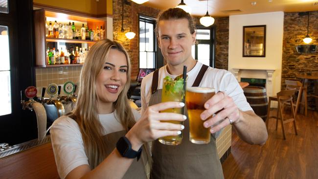 Staff members Ebony Sheridan and Wade Richardson toast the opening of the revamped General Havelock Hotel. Picture: Brett Hartwig