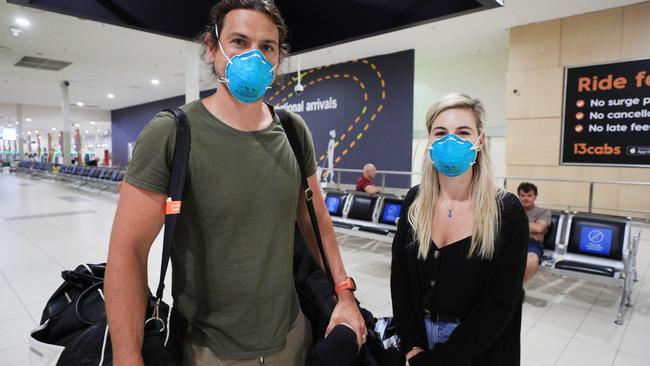 Mark Baruksopulo and wife Melyssa Baruksopulo arrived on the last flight from Adelaide before Queensland closes its borders to South Australia. Picture: Scott Powick.