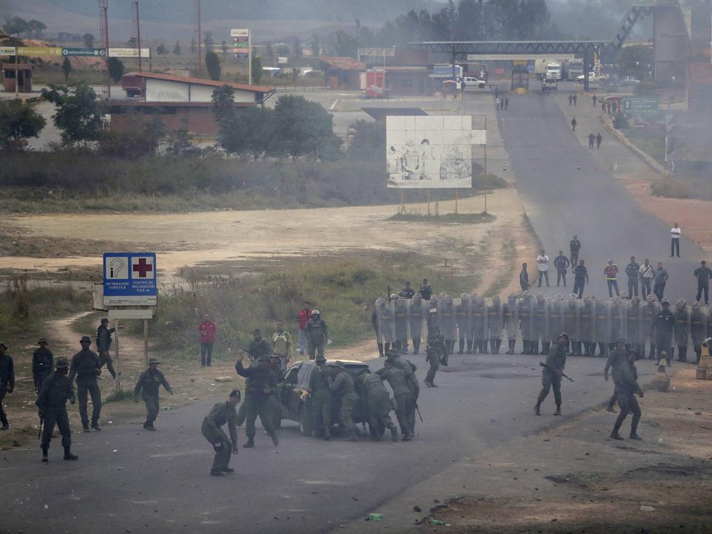 Venezuela's Bolivarian National Guard officers block the border between Brazil and Venezuela during clashes. Picture: AP