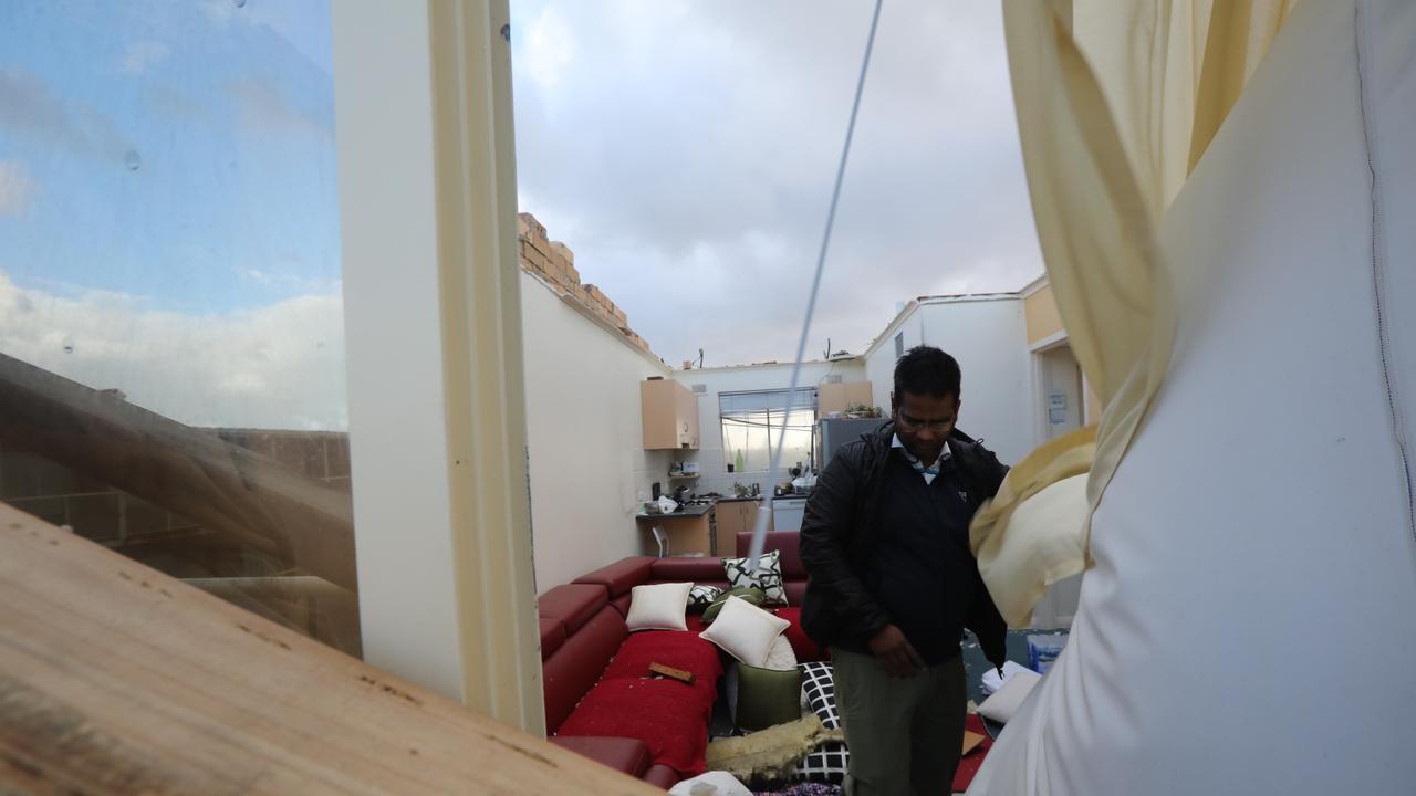 Surinder Kumar surveys the damage inside his apartment.  Picture: AAP / Russell Millard