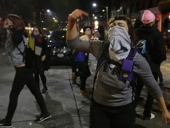 A woman yells as she takes part in a protest against on Wednesday morning in Seattle's Capitol Hill neighbourhood. Picture: Ted S. Warren/AP