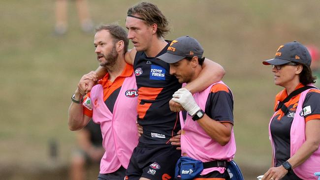 Will Setterfield is helped off the field after injuring his knee. Picture: Jonathan Ng