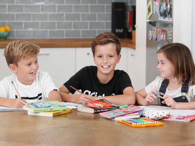 Pictured doing English school work at their home in Balgowlah are siblings Lachie Cuschieri (8) Tom Cuschieri (10) and Harriet Cuschieri.Picture: Richard Dobson