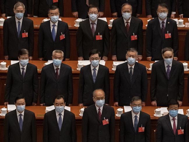 BEIJING, CHINA - MAY 22: Chinese Communist Party delegates, all wearing protective masks, stand during the national anthem at the opening of the National People's Congress at the Great Hall of the People on May 22, 2020 in Beijing, China. China opened its annual parliamentary gathering, known as 'The Two Sessions', at the Great Hall of the People on May 21 after being postponed at the heigh of the coronavirus outbreak in China earlier this year. (Photo by Kevin Frayer/Getty Images) *** BESTPIX ***