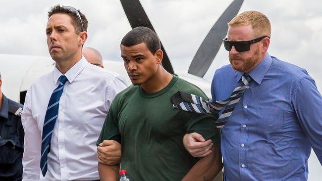 Jermaine Austral is escorted by police upon his return to Alice Springs. Photo: EMMA MURRAY