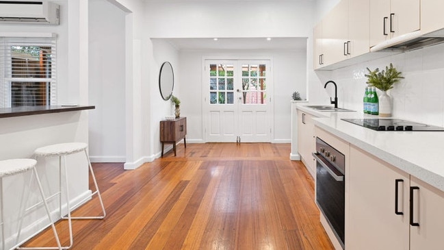 The post-war home retains its original timber floorboards.