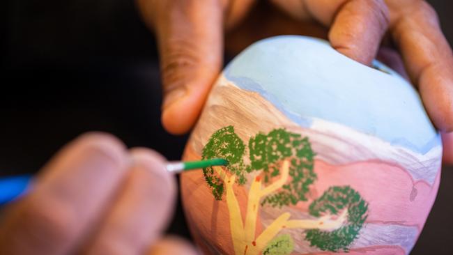 A Hermannsburg Potters artist painting a pot. Picture: Supplied