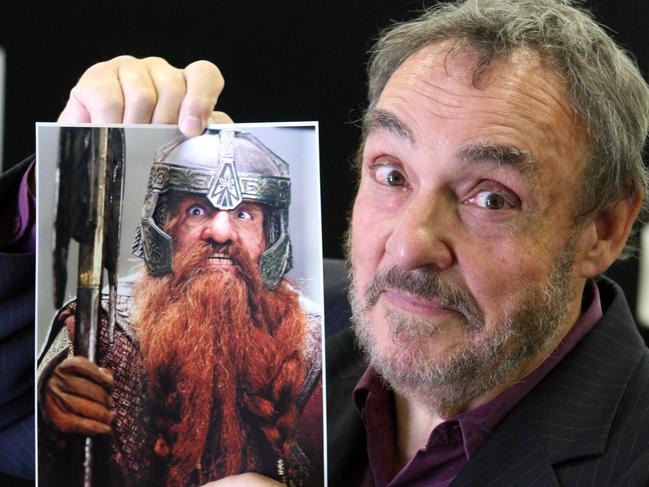 John Rhys-Davies with a photo of his Lord of the Rings character Gimli.