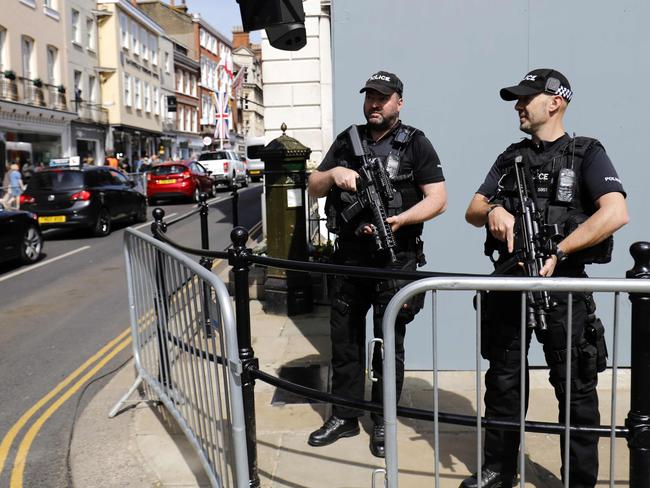 Armed British police officers patrol the streets of Windsor the day before the royal wedding. Picture: AFP Photo / Tolga Akmen