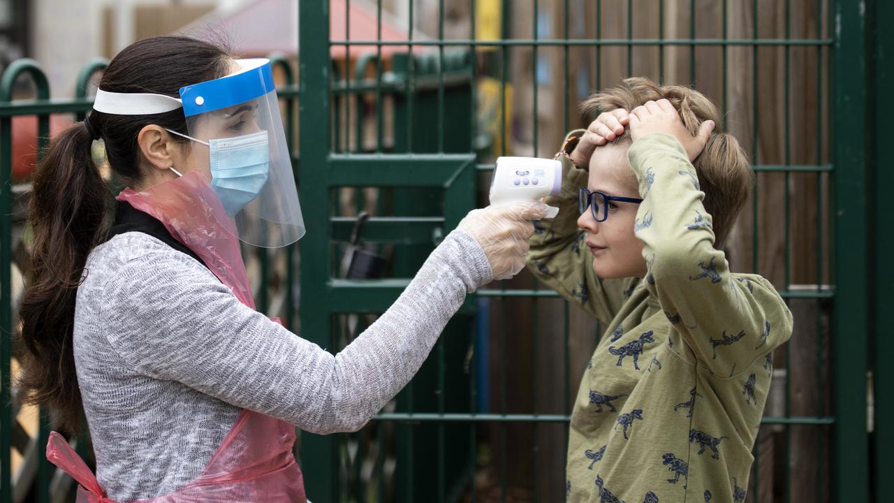 Child has his temperature taken at Harris Academy's Shortland's school in England where the Delta strain has surged among young people. Picture: Dan Kitwood/Getty Images