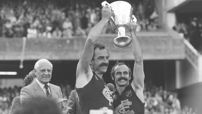 Peter Jones holds the 1979 Premiership Cup aloft with Alex Jesaulenko.